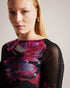 CATYELA-Tops-CATYELA seamlessly blends femininity with edge. The slashed straight neckline creates a bold stylish statement, while the 3/4 sleeves with fluted cuff add a delicate and romantic touch. The ruched seam through the sleeves adds texture and dimension, elevating the overall look. Brilliantly versatile, this top looks great with anything from boyfriend jeans to a leather skirt. Mesh top Slim fit Floral print Slashed straight neckline 3/4 sleeves with fluted cuff Ruched seam through sleeves- Ted Bak